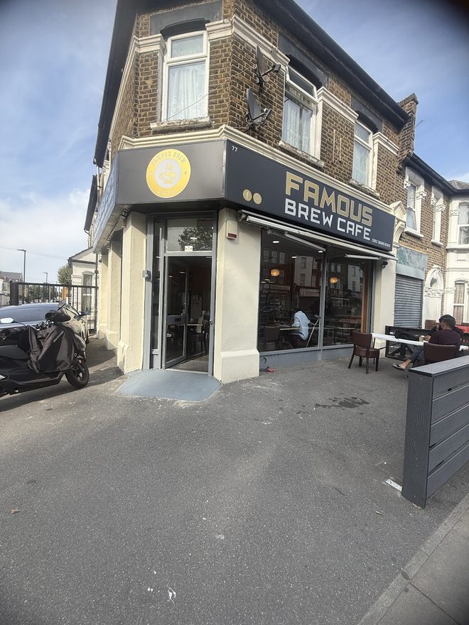 Corner view of the building with the cafe on the ground floor and outdoor seating