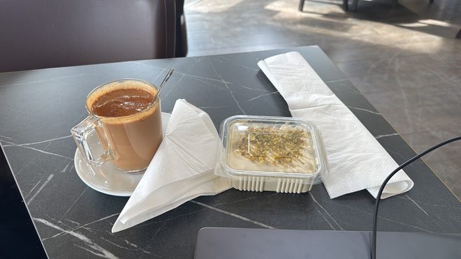 Tea in a glass cup on a sunlit table