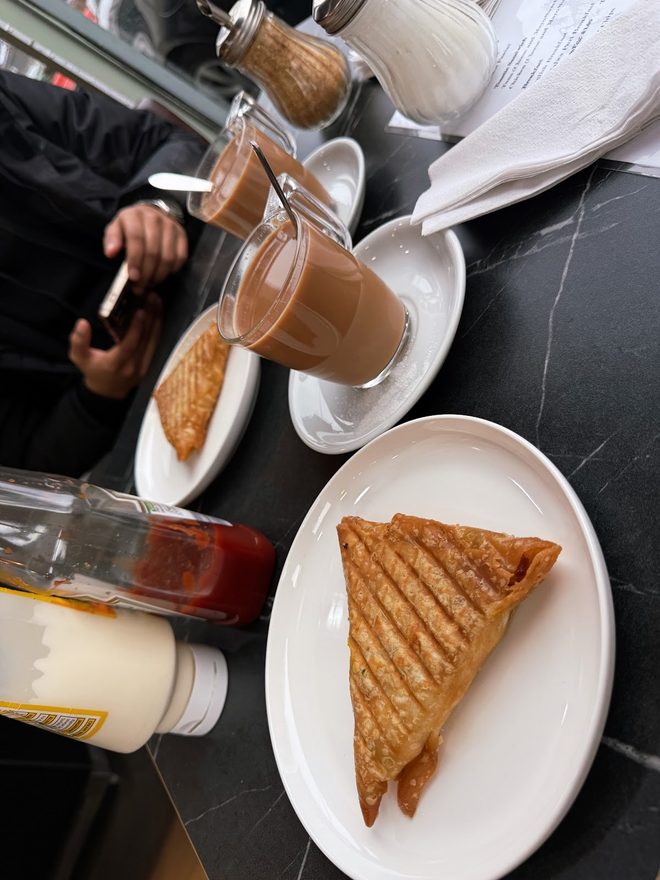 Toasted sandwich and lattes on a marble table