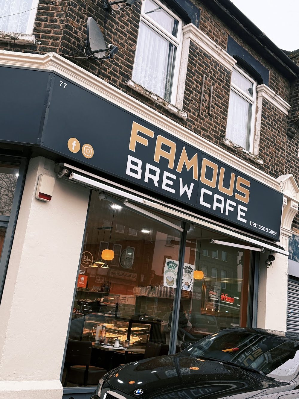 The cafe frontage at dusk with lit windows and cars parked outside on Plashet Road