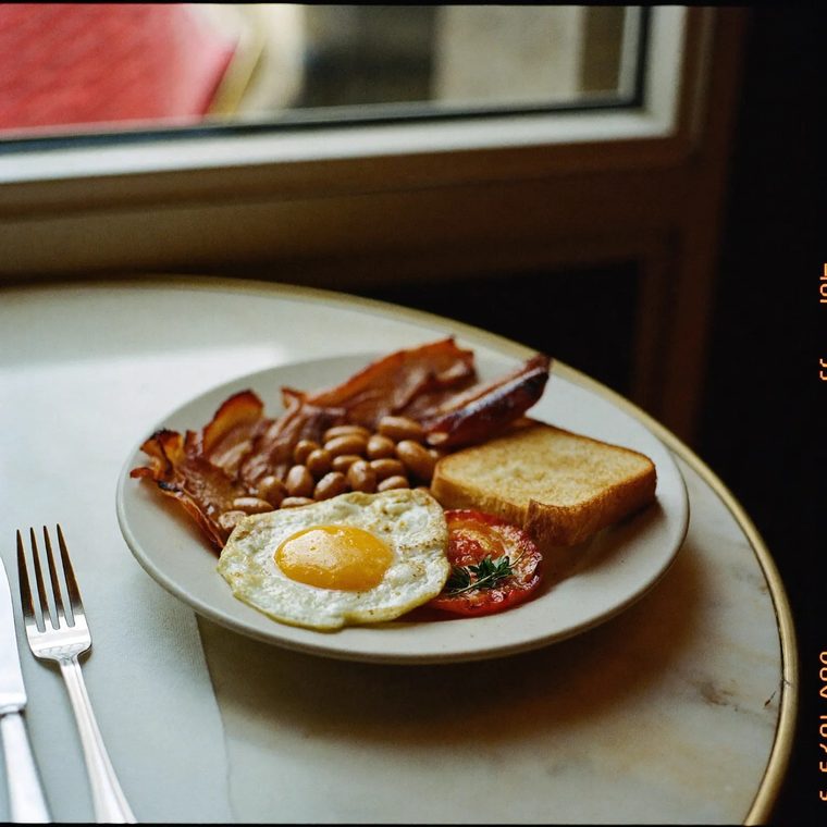 Cooked breakfast plated on a marble table